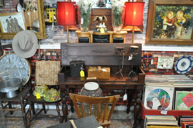 An antique desk with red lamps, framed paintings and crates of record albums at Sample Studios